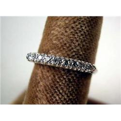 A 14K WHITE GOLD, DIAMOND AND GOLD WEDDING RING: With nine circular single cut diamonds, total estim