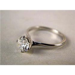 A 18K WHITE GOLD AND DIAMOND ENGAGEMENT RING With a round brilliant cut diamond, weighing apx. 1.05 