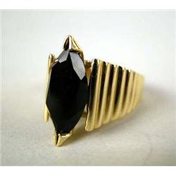A 14K YELLOW GOLD, ONYX, AND GOLD RING IN A NAVETTE SHAPE The ring is stamped "DRA 14K",
