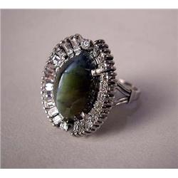 A CAT'S EYE AND DIAMOND RING IN PLATINUM AND WHIT