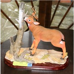 NEW DEER STANDING BY TREE STATUE