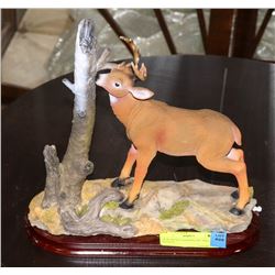 NEW DEER STANDING BY TREE STATUE