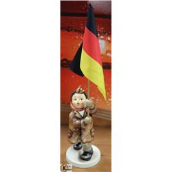 COLLECTIBLE HUMMEL FIGURE HOLDING GERMAN FLAG.