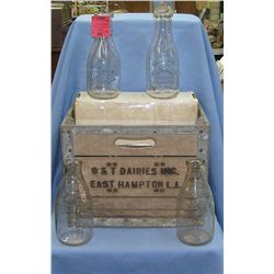 Group of antique milk bottles with crate