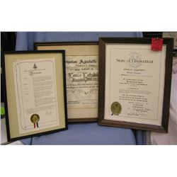 Three framed awards and proclamations