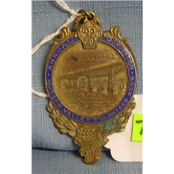 Antique brass and blue enameled badge