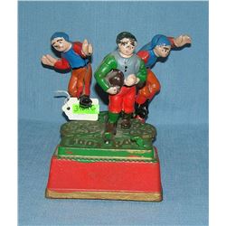 Hand painted cast iron football mechanical bank