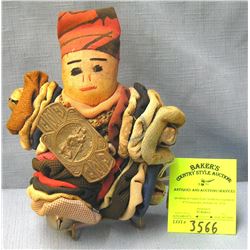 Antique doll with bells and decorations