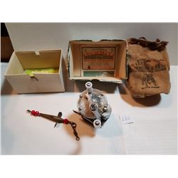 VINTAGE FISHING REEL WITH RED GLASS BEADS LURE