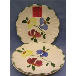 Group of four floral decorated serving plates