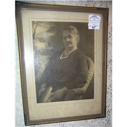 Antique photograph of a woman in a wicker chair