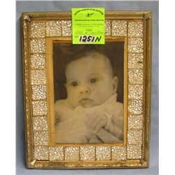 Vintage baby photo in decorative frame