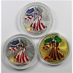 THREE COLORIZED AMERICAN SILVER EAGLES