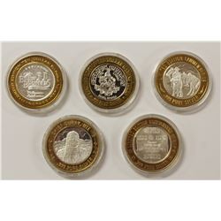 FIVE MISCELLANEOUS SILVER CASINO TOKENS