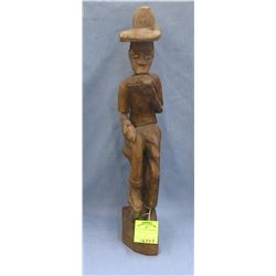 Hand carved African male figure eating corn