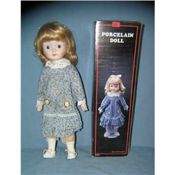 Blue and white dressed collectible porcelain doll in