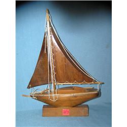 Hand carved wood sail boat on stand