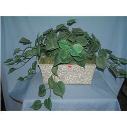 Large artificial plant in decorative tin flower pot