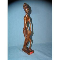 Hand carved African man playing the bongoes