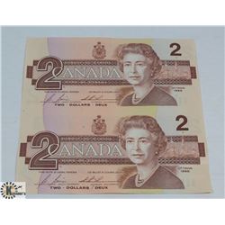 SET OF TWO 1986 UNCUT CANADIAN $2 BILLS.