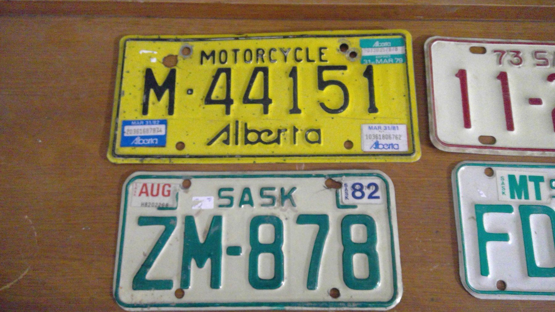 FOUR MOTORCYCLE PLATES SASKATCHEWAN AND ALBERTA