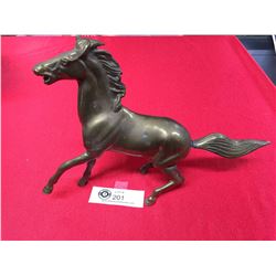 A 9" tall x 12" L Brass Horse.