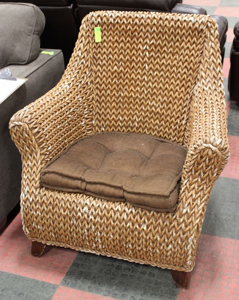WICKER ARM CHAIR W/ BROWN CUSHION.