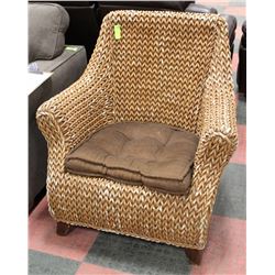 WICKER ARM CHAIR W/ BROWN CUSHION.