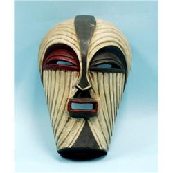A hand carved wooden African tribal mask with mul