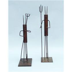 A pair of unusual iron figures, each depicting a 