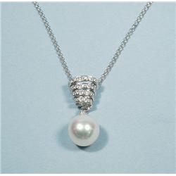 A swirl form 18 kt. white gold pendant decorated 