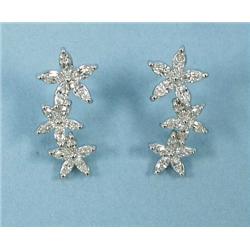 A pair of 18 kt. white gold and diamond earrings.