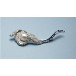 An 18 kt. white gold, sapphire and diamond brooch