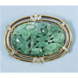 A well carved green jade pendant brooch set in a 