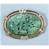 Image 1 : A well carved green jade pendant brooch set in a 
