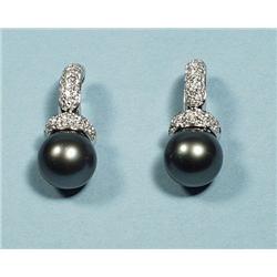 A pair of 18 kt. white gold and diamond earrings,