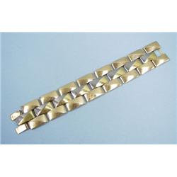 A wide 18 kt. three tone gold bracelet designed o