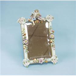 An antique German porcelain framed table mirror. 