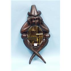 An unusual antique Irish wall mirror. The brown s