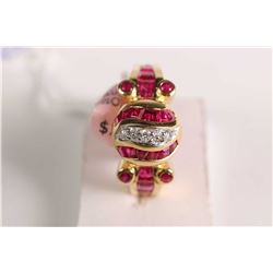 New old stock 18kt yellow gold, ruby and diamond ring. Set with 1.50ct of baguette channel set and r