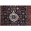 Image 2 : 100% wool Hossien Abad carpet with center medallion, dark blue background and highlights of pink, ta