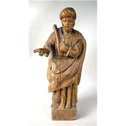 A CARVED PINE FIGURE OF A BEARDED AND R