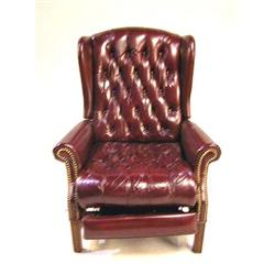A BURGUNDY LEATHER UPHOLSTERED RECLINER