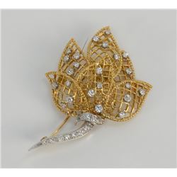 18 karat yellow gold floral pin with white gold stem.
