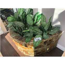 BRICK PLANTER WITH EVERGREEN PLANTS.