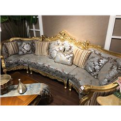 SPECTACULAR CARVED WOOD FRAME SECTIONAL SOFA WITH FLORAL PRINT AND THROW CUSHIONS.