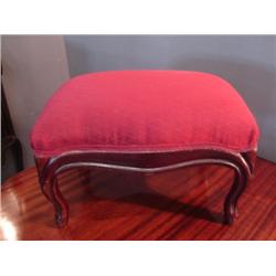 red upholstered footstool 