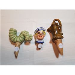 THREE ANTIQUE CERAMIC BOTTLE TOPPERS