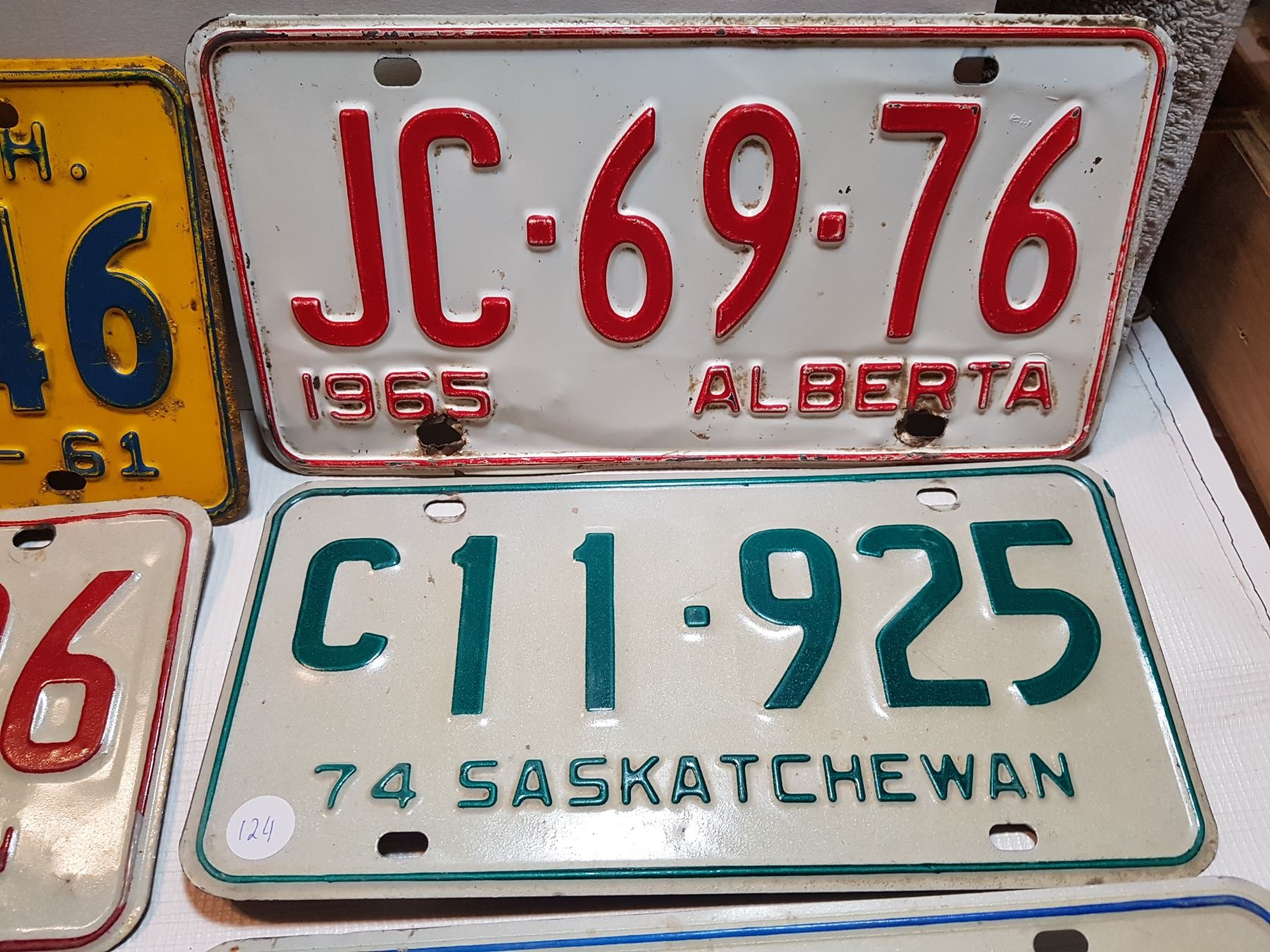 7 SASKATCHEWAN LICENSE PLATES AND 2 ALBERTA LICENSE PLATE