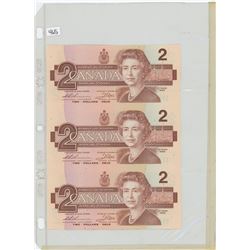 Uncut partial sheet of 3 1986 $2 notes. Thiessen-Crow signatures.